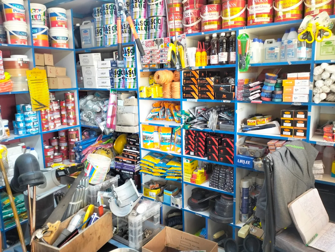Inside Quba Hardware store showing well-stocked shelves of building materials